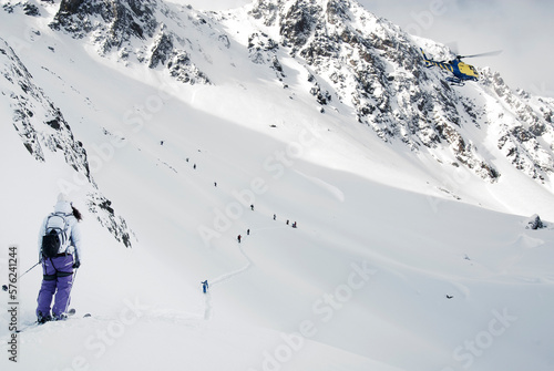 Group of skiers hiking up snowcapped slope in Pyrenees before in preparation for skiing competition, Andorra photo