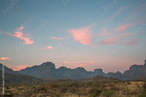 A Mountain Range In The Distance Under A Softly Glowing Dawn Sky