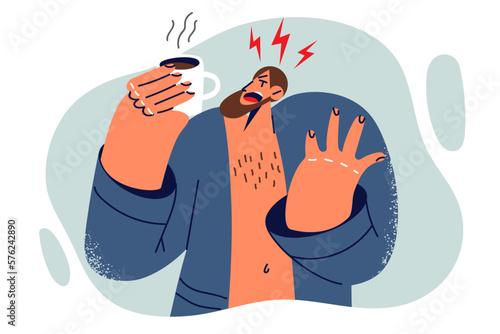 Man screaming in pain after being burned by hot coffee during breakfast and yelling aggressively