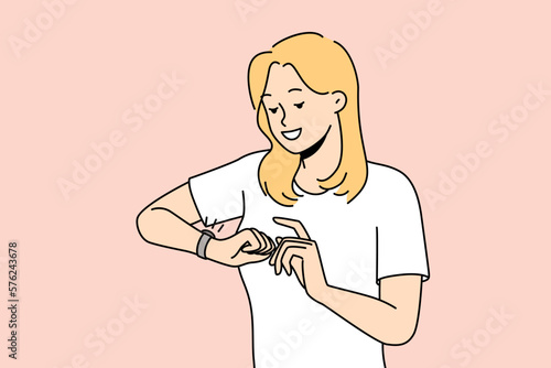 Smiling woman look at wristwatch check time. Happy girl use classic analogue watch on wrist. Time management and deadline. Vector illustration. 