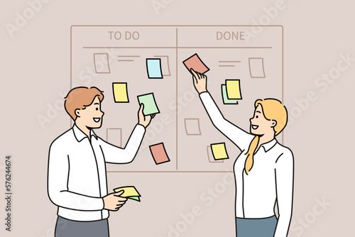 Smiling businesspeople brainstorm manage tasks on scum board in office. Happy employee discuss business projects at workplace. Teamwork and time management. Vector illustration. 
