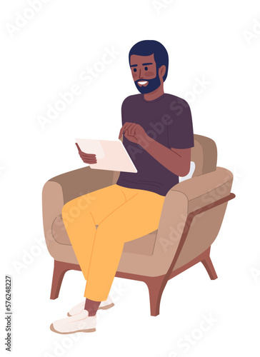 Excited man with tablet resting in armchair semi flat color vector character. Editable figure. Full body person on white. Simple cartoon style spot illustration for web graphic design and animation