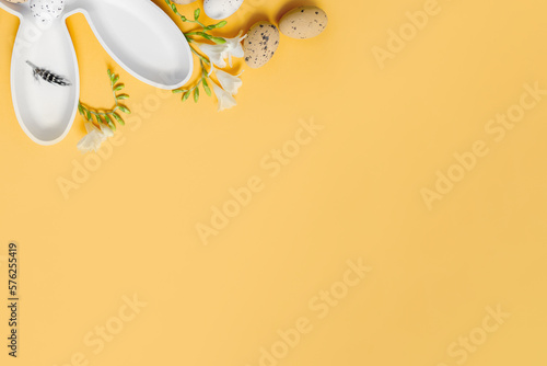 Canvas Print creative easter layout with white plate bunny and easter eggs on yellow background
