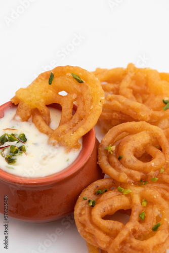 Indian Kesari Jalebi Also Called Jilapi, Jilebi, Jilipi, Zulbia, Jerry, Zalebi, Mushabak Topped With Creamy Lachhedar Malai Rabri Also Called Khurchan Rabdi, Lachha Rabidi Consumed On Diwali And Holi photo