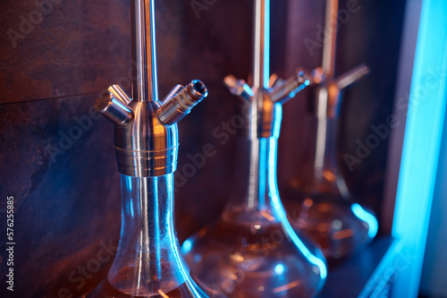 Closeup hookahs with glass flask and metal bowl selective focus