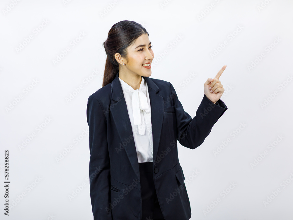 Portrait isolated cutout studio shot Millennial Asian professional successful female businesswoman in formal business suit pants standing smiling holding hand presenting product on white background Portrait isolated cutout studio shot Millennial Asian professional successful female businesswoman in formal business suit pants standing smiling holding hand presenting product on white background