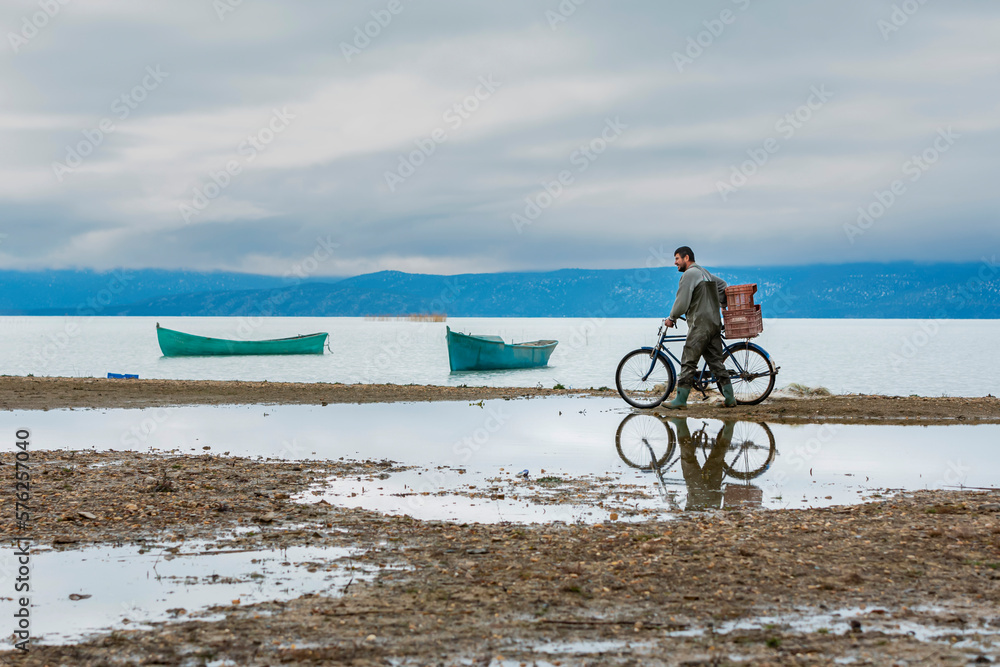 Fototapeta premium person riding a bike on the beach