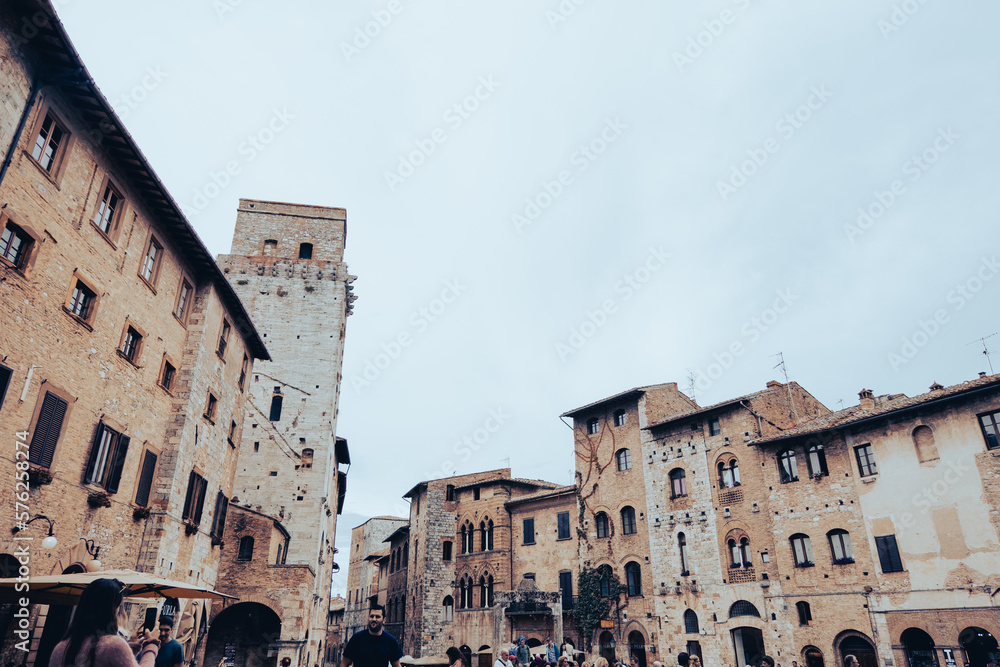 Low angle view of the medieval buildings and a bell tower of a small village in the mountains in Tuscany