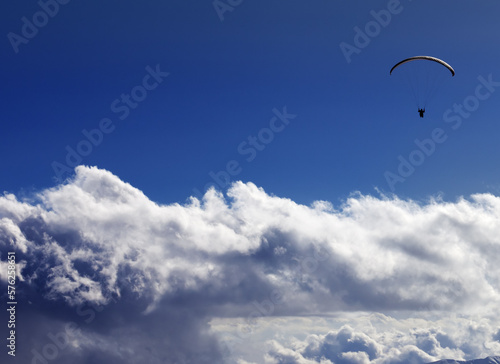 Silhouette of paraglider and blue sunny sky. Caucasus Mountains. Georgia, view from ski resort Gudauri. © BSANI