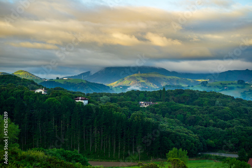 landscape with forest and mountains, mountain peaks in the clouds. Basque Country, Spain