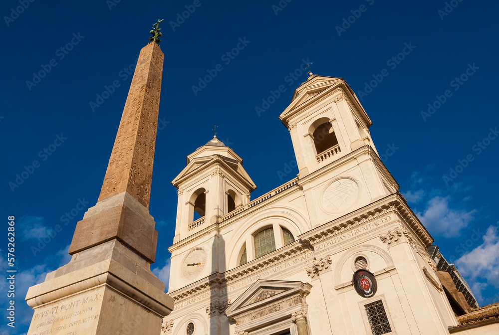 Twin bell towers of Trinità dei Monti renaissance church with ancient egyptian obelisk, at the top of famous Spanish Steps, in the center of Rome