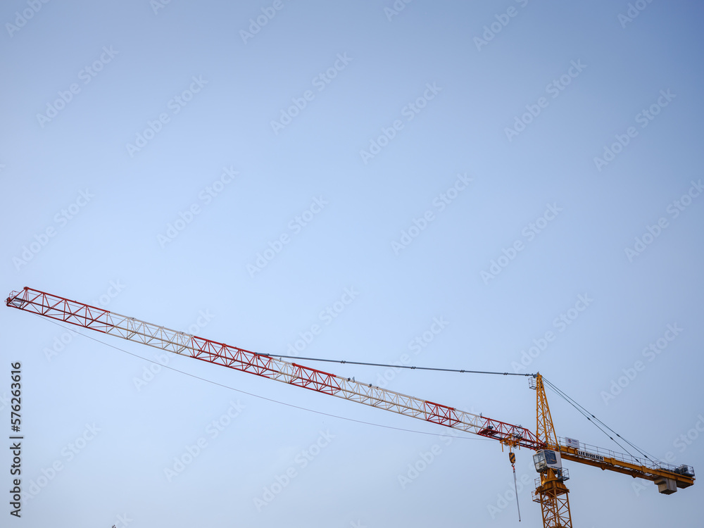 Silhouette of construction crane against cloudy sky. Housing construction, apartment block in city, restoration work in the city . Summer Travel to capital of Austria Vienna. Silhouette of construction crane against cloudy sky. Housing construction, apartment block in city, restoration work in the city . Summer Travel to capital of Austria Vienna.