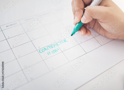 Hands, writing and calendar planning contractor commitment or appointment for organized reminder. Hand of person with blue marker to write time or project management on construction schedule planner