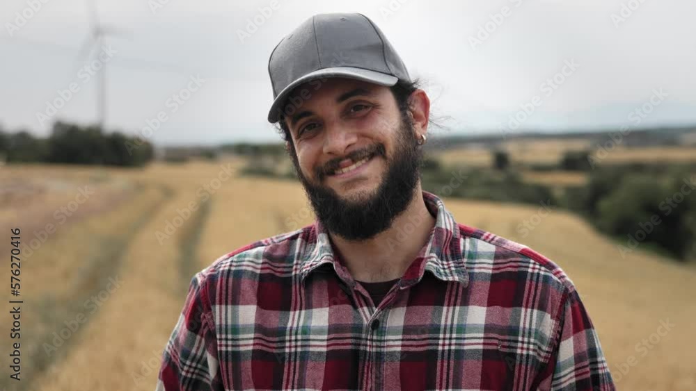 Farmer in the wheat field looking to camera with smile - Professional Worker Portrait Farmer in the wheat field looking to camera with smile - Professional Worker Portrait