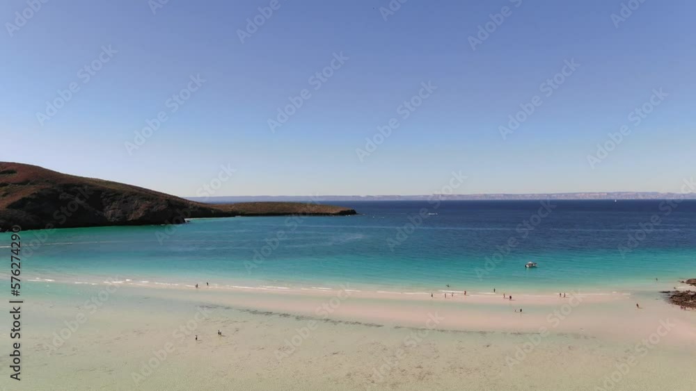 Aerial above tourists walking in shallow clear water in Balandra Bay, Baja Sur, Mexico Aerial above tourists walking in shallow clear water in Balandra Bay, Baja Sur, Mexico