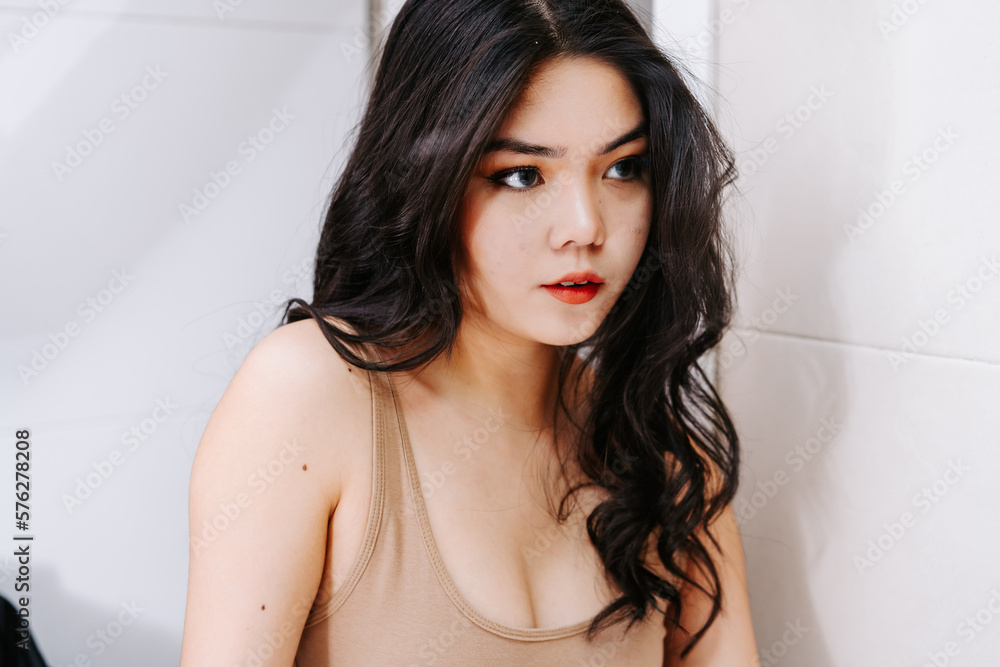Head shot close up smiling asian young woman using cosmetics brush, looking in mirror, beautiful girl putting daily makeup, applying powder, standing in bathroom after shower Head shot close up smiling asian young woman using cosmetics brush, looking in mirror, beautiful girl putting daily makeup, applying powder, standing in bathroom after shower