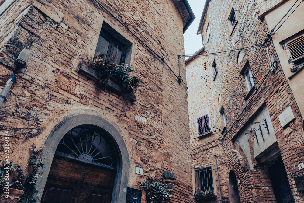 Medieval buildings in an alley of a village built in the mountains in Tuscany