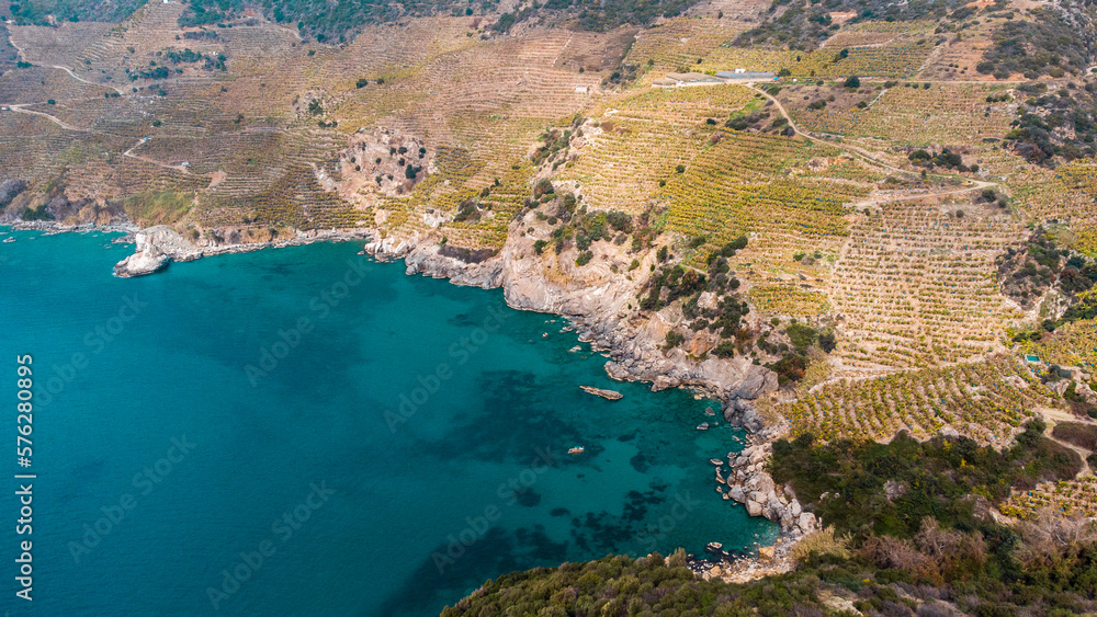 Turquoise bay and banana plantations on mountainside from a bird's-eye view. 