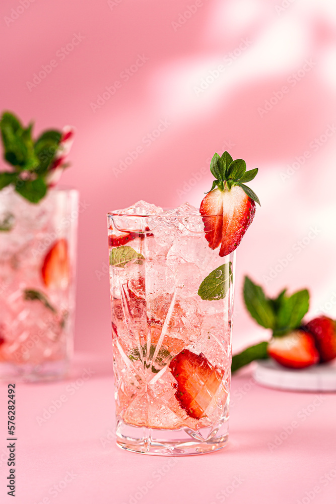 Fresh cocktail with crushed ice, strawberry and mint on pinkbackground. Summer cold drink concept with copy space Fresh cocktail with crushed ice, strawberry and mint on pinkbackground. Summer cold drink concept with copy space