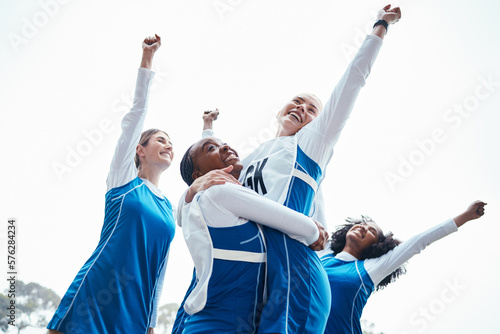 Fototapeta Naklejka Na Ścianę i Meble -  Women, friends and celebration for winning, sports team or success raising fist together in the outdoors. Happy sporty woman group smiling in sport teamwork celebrating win, victory or achievement