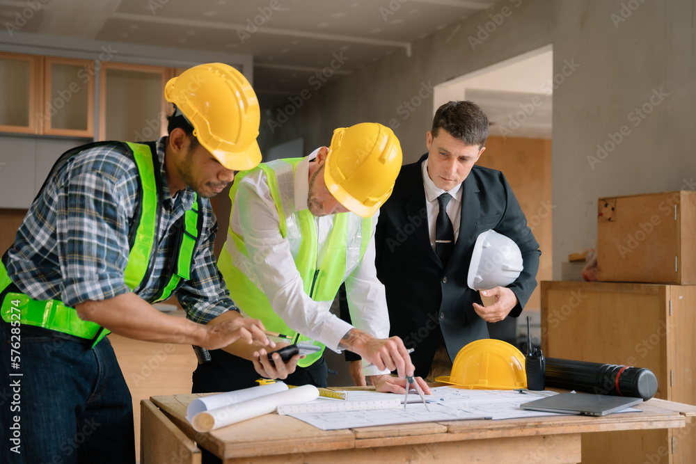 Working as a team architect and designer working on blueprint project of new apartments. Photo concept of work on technical drawings in construction site. Working as a team architect and designer working on blueprint project of new apartments. Photo concept of work on technical drawings in construction site.