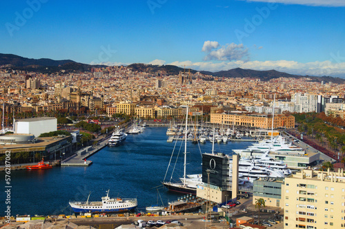 Barcelona, Spain-January 02,2016:Scenic aerial landscape view of Port Vell with moored yachts and ships. Downtown of Barcelona in the background. Travel and tourism concept. Cityscape at sunny day © evgenij84