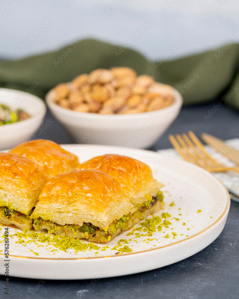 Pistachio baklava on white marble. Traditional middle eastern dessert. Turkish Antep baklava. Pistachio baklava on white marble. Traditional middle eastern dessert. Turkish Antep baklava.
