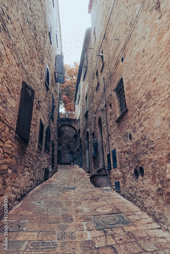 Ancient buildings in an alley of a village built in the mountains in Tuscany