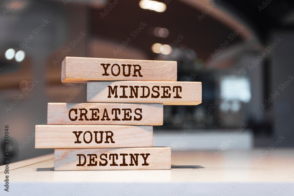 Wooden blocks with words 'Your Mindset Creates Your Destiny'.