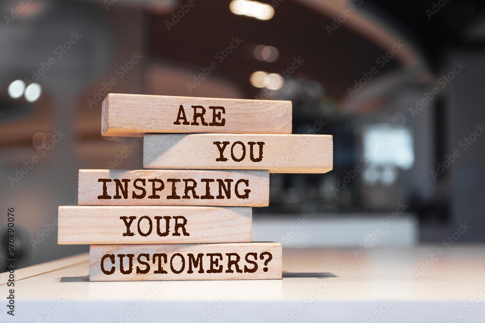 Wooden blocks with words 'Are You Inspiring Your Customers?'.
