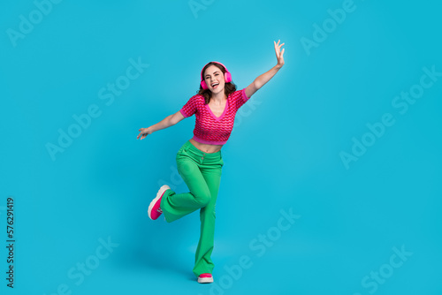 Fototapeta Naklejka Na Ścianę i Meble -  Full length photo of cheerful lovely lady wear trendy retro clothes chill vibe summer party empty space isolated on blue color background