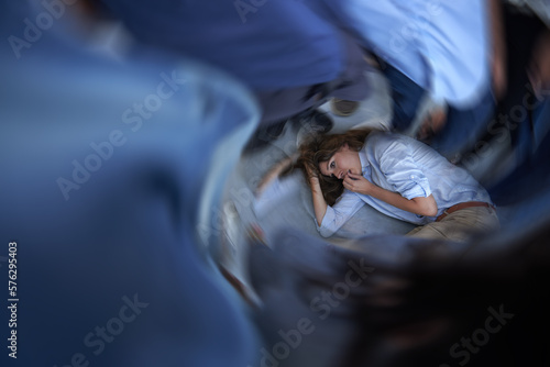 Its all too much. Shot of a young woman curled up on the floor in a panic state.