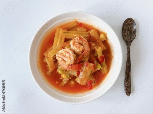 Top view Thai Moringa curry with shrimp isolated on white blackground, hot and sour flavour.(Kaeng som marum) photo