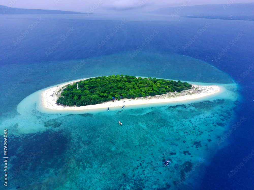 The Tabuhan Island in the beautiful clear waters of the Bali Straits.