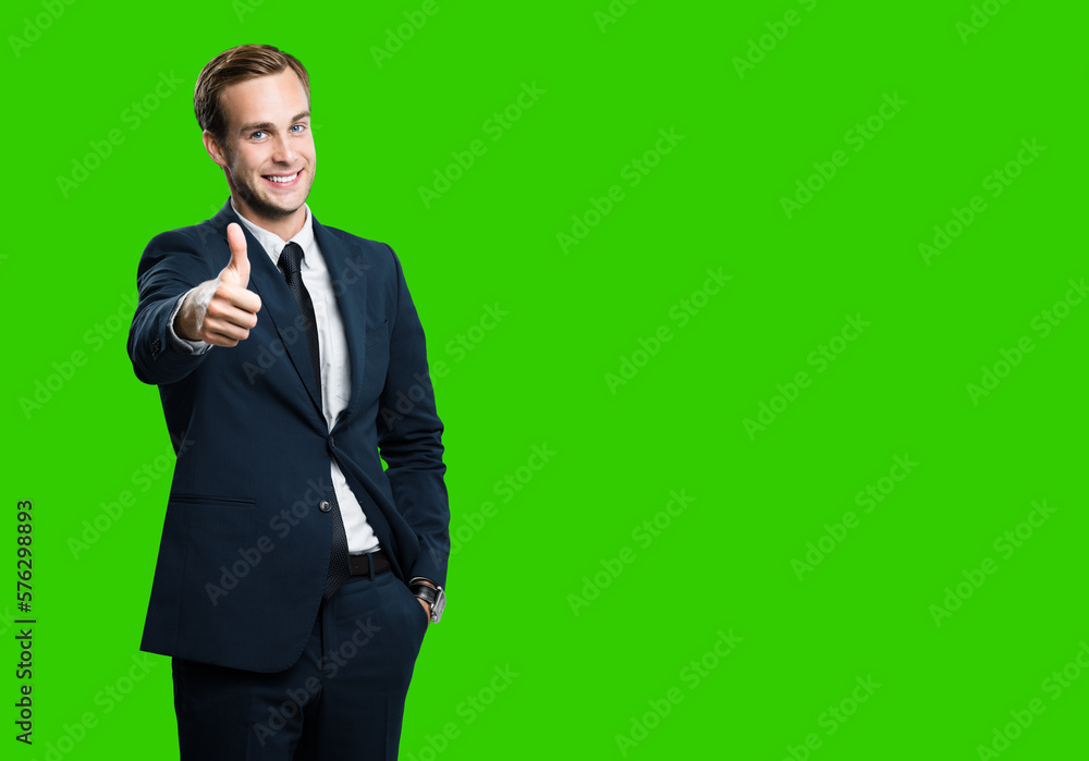 Excited businessman showing thumb up like sign gesture, in black confident style suit, green chroma key background. Handsome happy man. Copy space for slogan or text. Excited businessman showing thumb up like sign gesture, in black confident style suit, green chroma key background. Handsome happy man. Copy space for slogan or text.