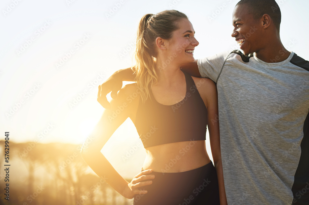 Fototapeta premium Keeping each other healthy and happy. Shot of a fit young couple working out together outdoors.