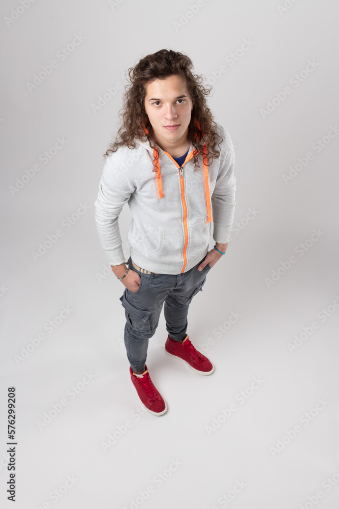 Young man in skinny jeans, hands-in-pockets, above view Young man in skinny jeans, hands-in-pockets, above view