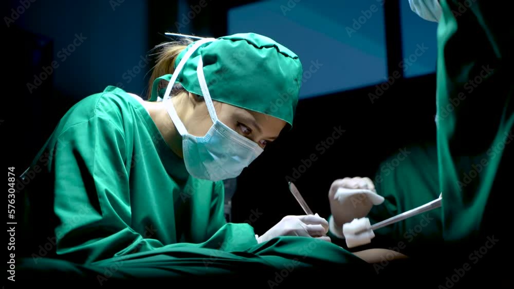 4K, Doctor performs urgent surgery for a patient who is unconscious on operating bed, Two assistants with different roles, wiping the doctor's sweat and wiping the blood of the patient. 4K, Doctor performs urgent surgery for a patient who is unconscious on operating bed, Two assistants with different roles, wiping the doctor's sweat and wiping the blood of the patient.