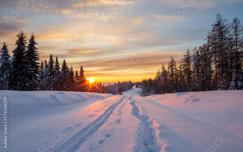 winter sunrise in the forest, snow-covered road on Holica in the Bieszczady Mountains