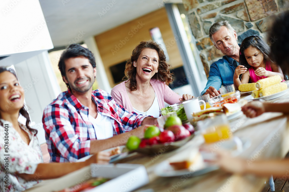 Enjoying mealtimes as a family. A happy family enjoying a meal time together. Enjoying mealtimes as a family. A happy family enjoying a meal time together.