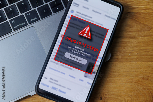 Virus warning notification on phone screen. Dangerous malware virus in phone Concept photo