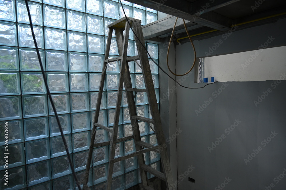 Obraz premium interior constuction site industry with glass block and steel ladder