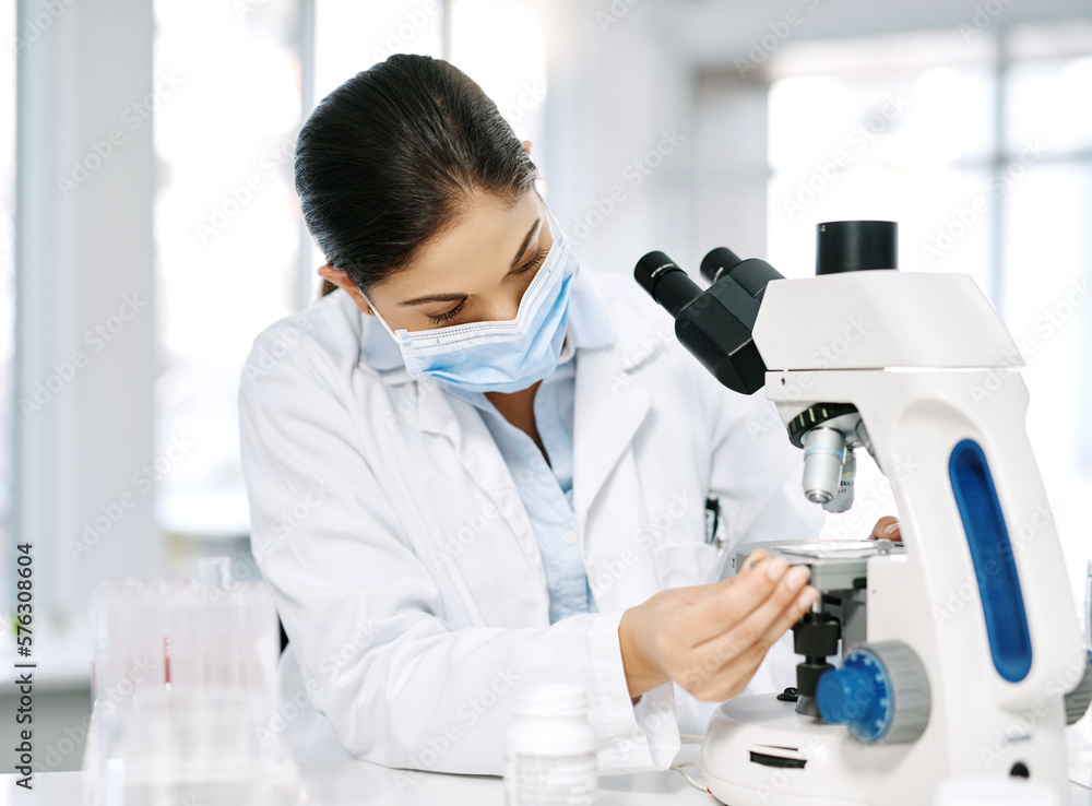 Some new samples came in for testing. Shot of a young scientist using a microscope in a lab. Some new samples came in for testing. Shot of a young scientist using a microscope in a lab.