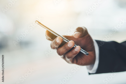 Making moves in the corporate world. Closeup shot of an unrecognisable businessman using a cellphone in an office.