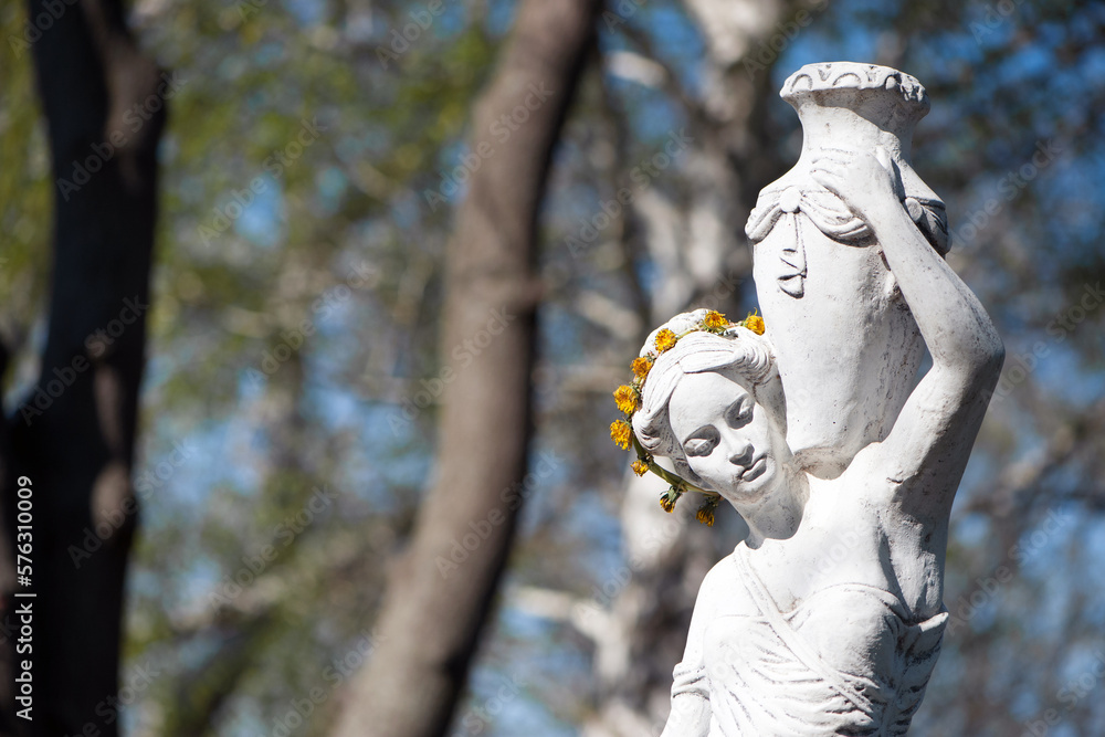 sculpture of a girl in the spring park. An old statue in a park of a sensual semi-nude Greek or Italian Renaissance woman with a vase in a city park. sunny day in the summer garden. close-up, vintage sculpture of a girl in the spring park. An old statue in a park of a sensual semi-nude Greek or Italian Renaissance woman with a vase in a city park. sunny day in the summer garden. close-up, vintage