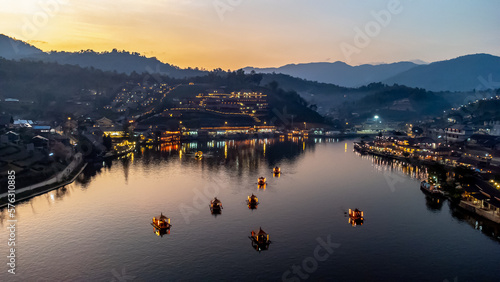 High angle view of tourists boarding a boat at Ban Rak Thai, Mae Hong Son Province, Thailand photo