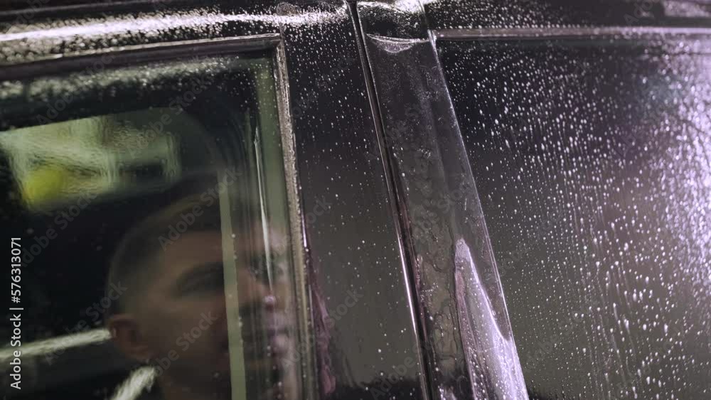 Man covering car with vinyl polyurethane tape. Films for the car. Sticker protective film on the car Man covering car with vinyl polyurethane tape. Films for the car. Sticker protective film on the car