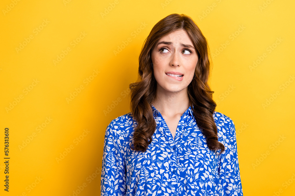 Photo of anxious embarrassed lady wear blue blouse look empty space dilemma question solution isolated on yellow color background Photo of anxious embarrassed lady wear blue blouse look empty space dilemma question solution isolated on yellow color background
