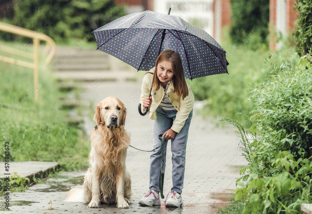 Girl with golden retriever dog in rainy day Girl with golden retriever dog in rainy day