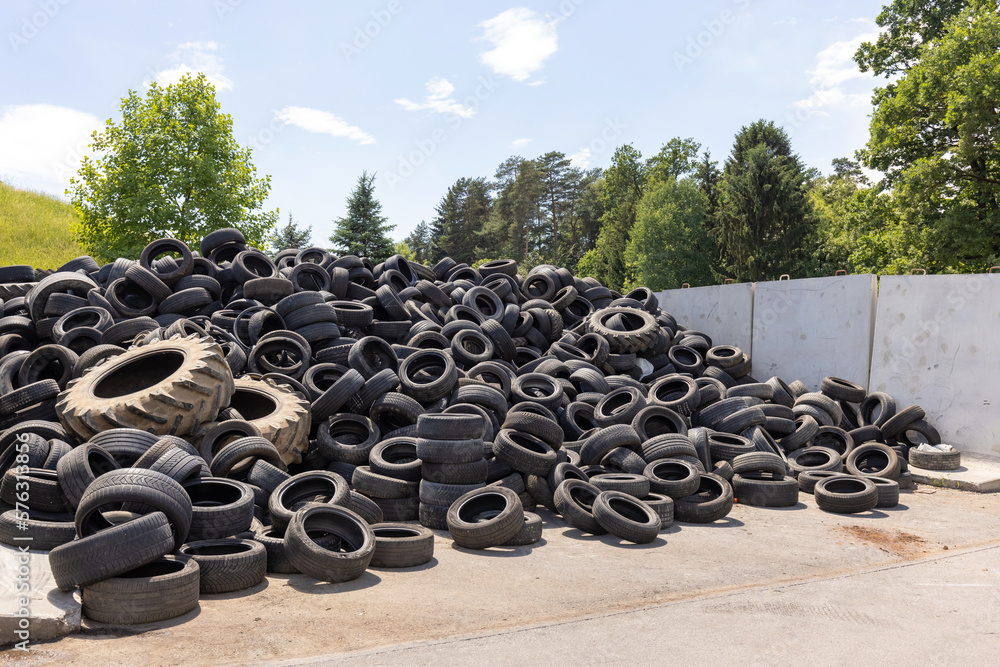 Heap of old used industrial rubber tires specially selected from the garbage in a recycling plant for separate recycling Heap of old used industrial rubber tires specially selected from the garbage in a recycling plant for separate recycling